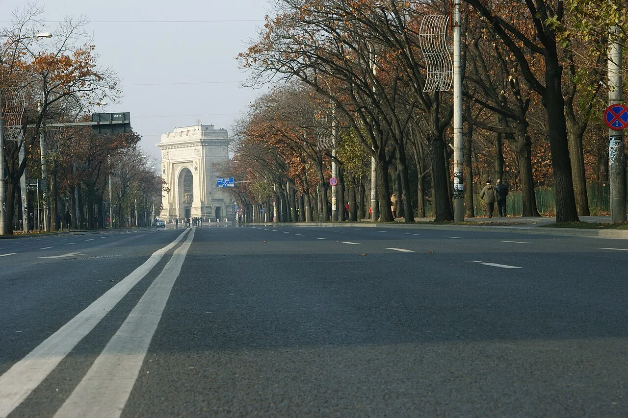 The Arcul de Triumf (Arch of Triumph) in northern Bucharest, standing at the end of a tree-lined boulevard