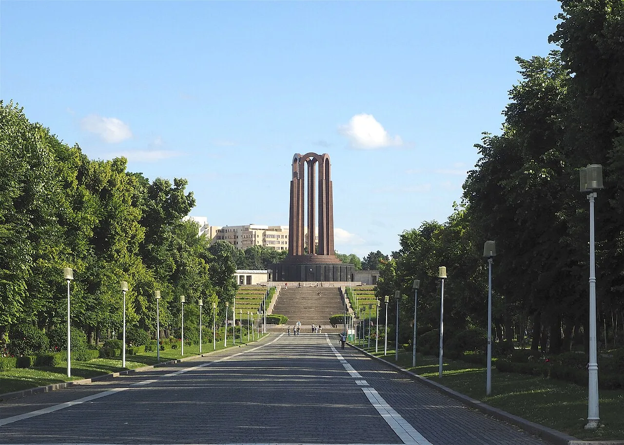 The formal tree-lined alley of Carol Park in Bucharest leading uphill to the Mausoleum monument